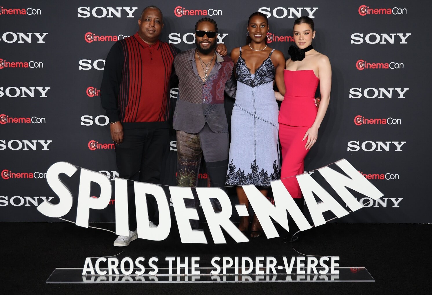 Kemp Powers, Shameik Moore, Issa Rae and Hailee Steinfeld posing for a photo a CinemaCon 2023 event