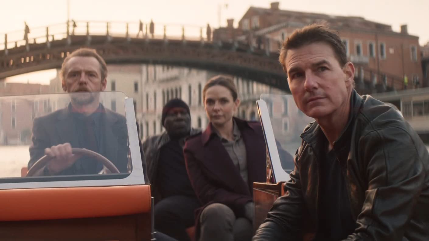 Simon Pegg, Rebecca Ferguson and Tom Cruise sitting on a boat in Venice Italy