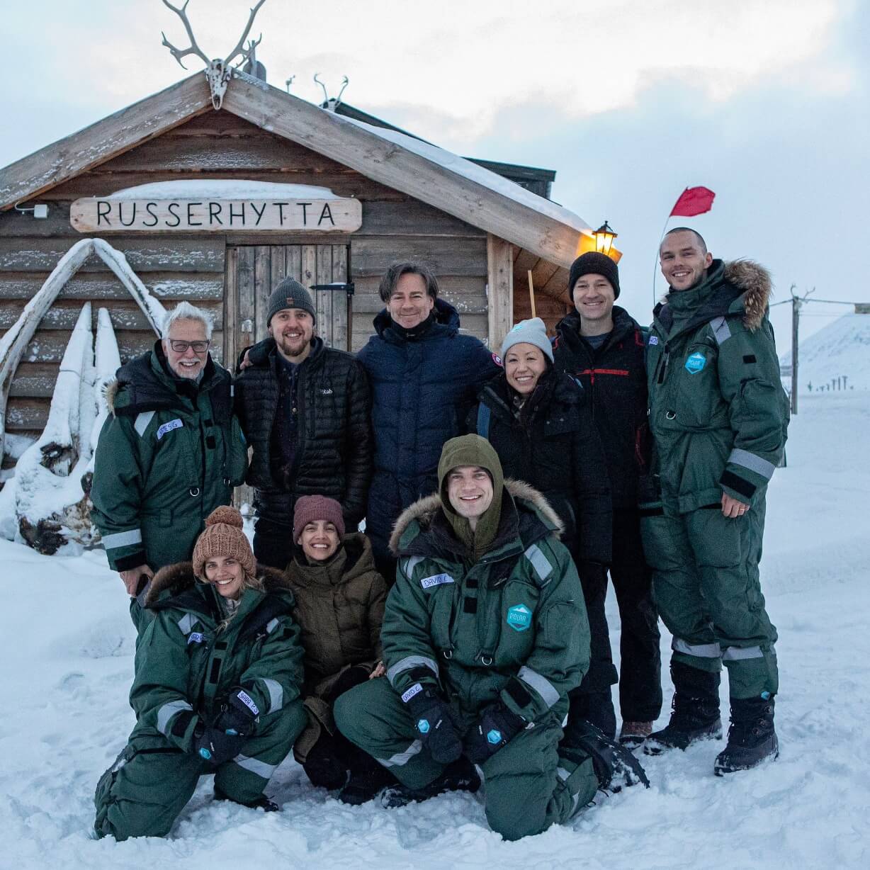 James Gunn, Peter Safran, David Corenswet, Nicholas Holt, María Gabriela De Faría and Sara Sampaio with two other individuals in snowy Norway, for Superman.