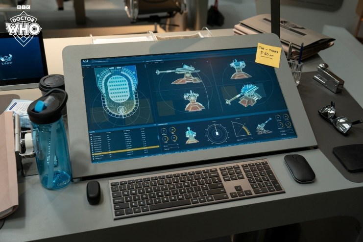 A desk at the new UNIT HQ in the Doctor Who, advanced weapons on the screens