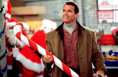 Arnold Schwarzenegger as Howard, holding a big candy cane in Jingle all the way