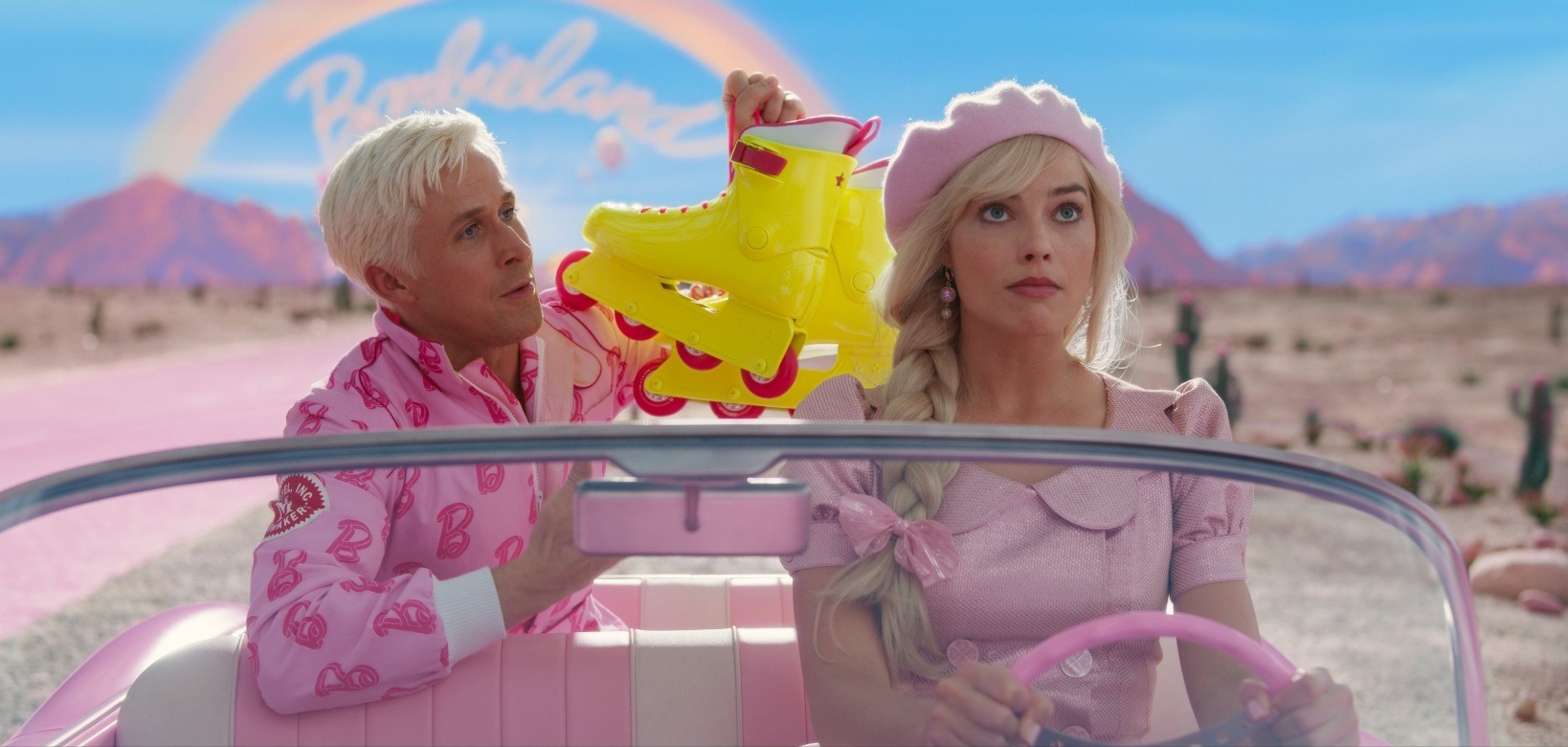 Ryan Gosling and Margot Robbie as Ken and Barbie in the barbie mobile