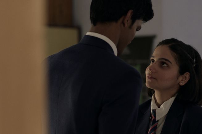 Mila and a boy are close looking into eachothers eyes. Girls Will Be Girls