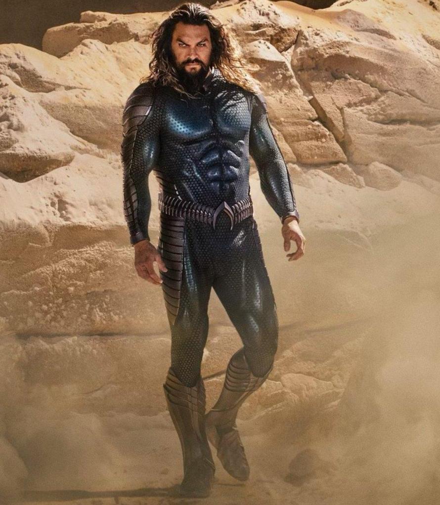 Jason Momoa as Arthur/Aquaman wearing his new black suit