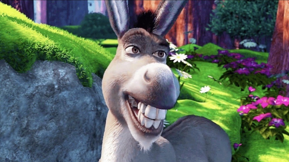 Smiling animated Donkey character from Shrek walking in a forest