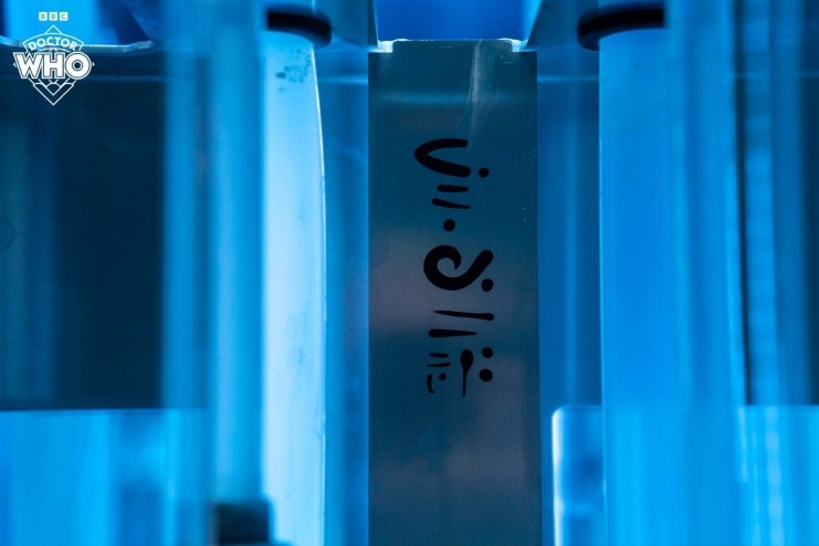 An unknown language on metal, with a blue background in the Doctor Who 60th Anniversary episode