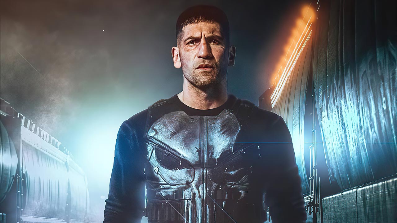 Jon Bernthal dressed in a black top with a skull print as The Punisher