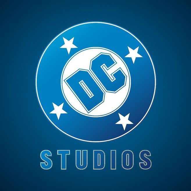 Blue background with a circle and 4 white stars in an inner circle, tilted DC letters in the centre and the capitalized word below: STUDIOS