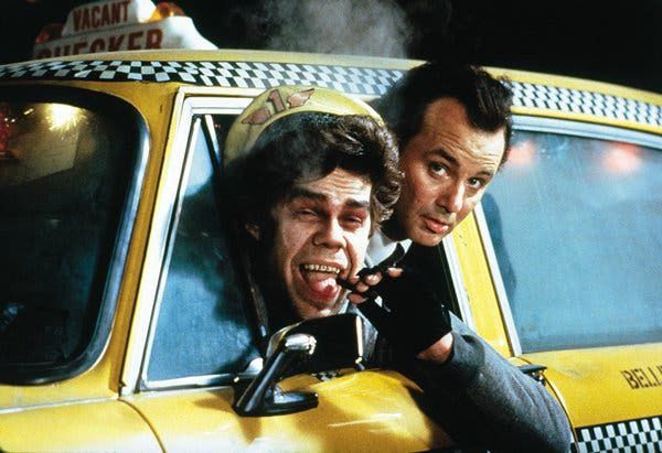 Bill Murray and David Johansen leaning out of a new york taxi cab