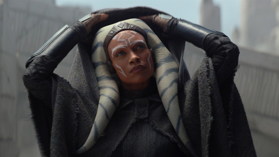 Rosario Dawson dressed as her character Ahsoka Tano, orange painted face with alien tendrils