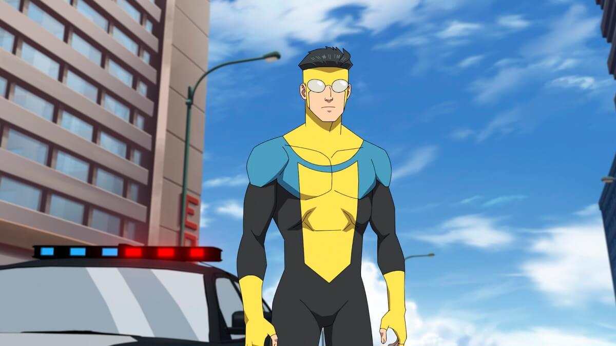 An animated Mark Grayson as Invincible, standing infront of a police car and a slightly cloudy blue sky.