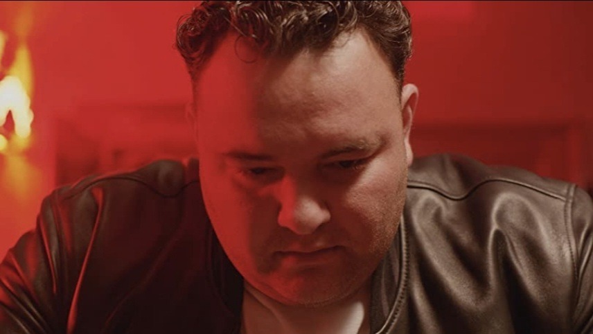 Gerard Garilli in Dress Code standing in a red lit room