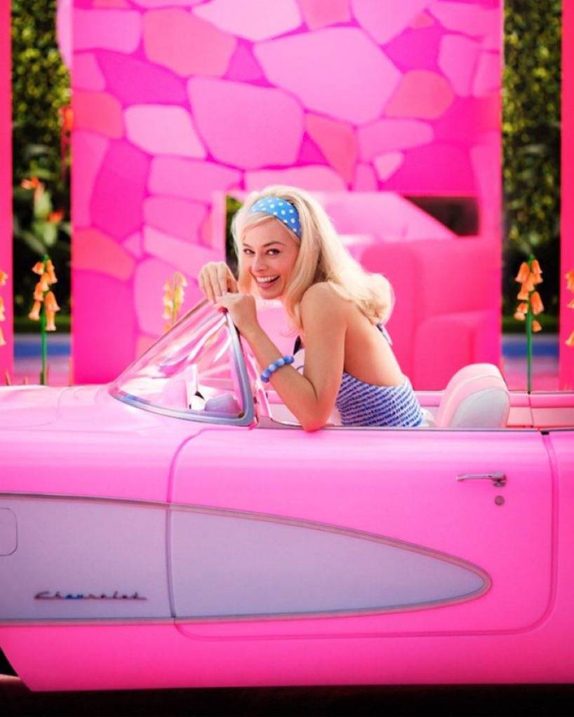 The first look of Margot Robbie as Barbie sitting in a car. 
