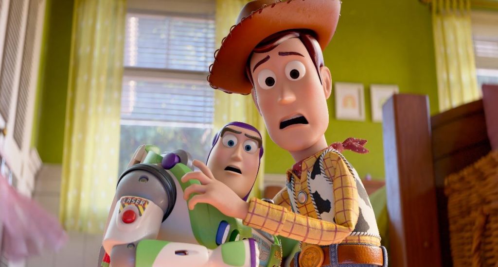 Buzz Lightyear and Woody are looking scared of something off screen, in Toy Story 5.